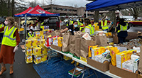 Volunteers distribute food assistance to Veterans